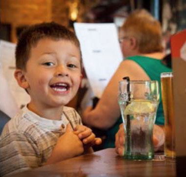 Happy kid enjoying a drink