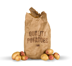 A large brown paper sack of potatoes with the top open. There are a few loose potatoes around the base.